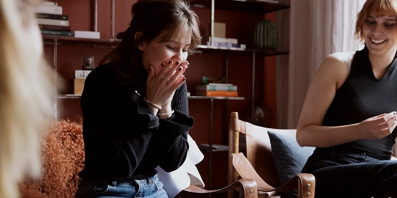 Kvinde overrasket og dækker munden med sine hænder